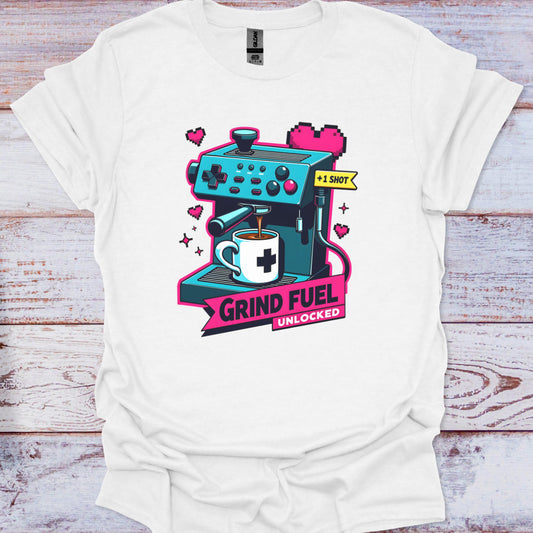 White t-shirt with a colorful graphic of a coffee machine and text on a wooden surface