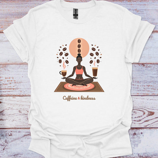 White t-shirt with a graphic of a person meditating surrounded by coffee beans and cups on a wooden surface.