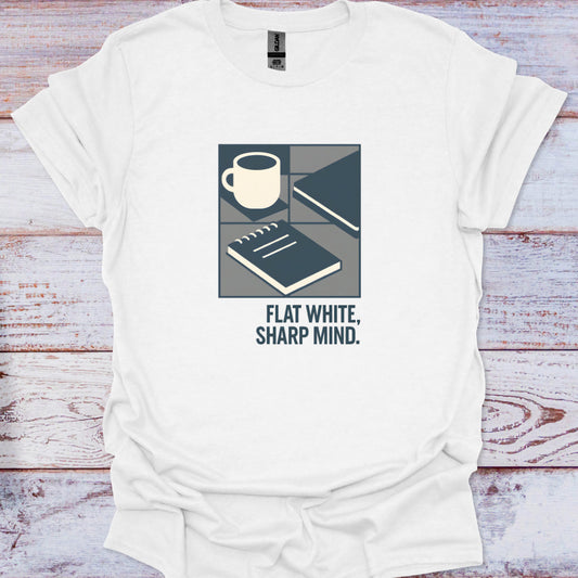 White t-shirt with a graphic design and text 'Flat White, Sharp Mind' on a wooden surface.