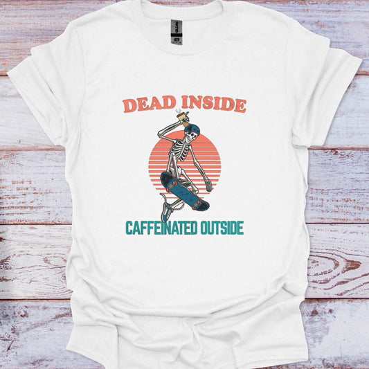 White t-shirt with skeleton design and text 'Dead Inside, Caffeinated Outside' on a wooden surface