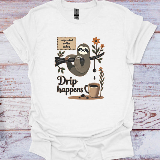 White t-shirt with a sloth and coffee-themed graphic on a wooden surface