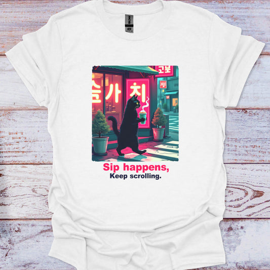 White t-shirt with a graphic of a cat in a black coat walking under a neon sign and text 'Sip happens, Keep scrolling.' on a wooden surface.