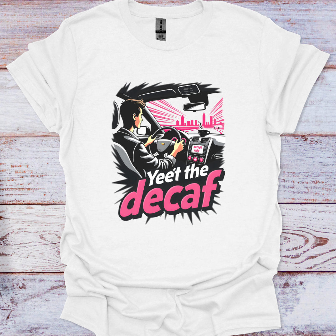 White t-shirt with a graphic design featuring a person driving a car and text 'Yeet the decaf' on a wooden surface.