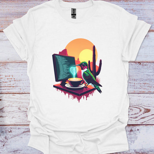 White t-shirt with a colorful graphic of a bird, computer, and cactus on a wooden surface