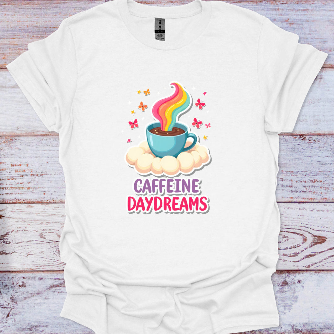 White t-shirt with a colorful coffee cup graphic and 'Caffeine Daydreams' text on a wooden surface.