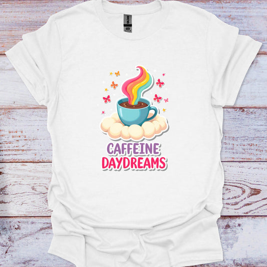 White t-shirt with a colorful coffee cup graphic and 'Caffeine Daydreams' text on a wooden surface.