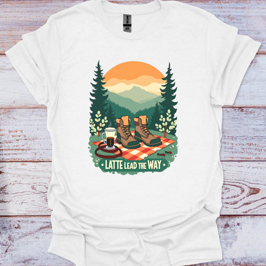 White t-shirt with a graphic design of hiking boots, coffee, and a sunset on a wooden surface