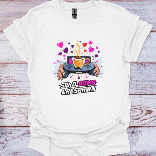 White t-shirt with a graphic design featuring a coffee cup and game controller on a wooden surface.