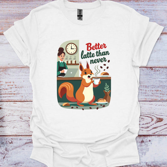 White t-shirt with a graphic of a squirrel drinking coffee and text 'Better latte than never' on a wooden surface.