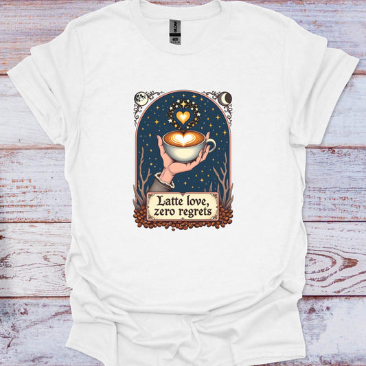 White t-shirt with a graphic design of a hand holding a coffee cup and text 'Latte love, zero regrets' on a wooden surface.