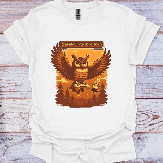 White t-shirt with an owl graphic and text on a wooden surface