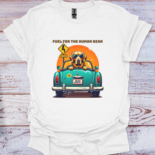 White t-shirt with a graphic of a dog in a car and text 'Fuel for the Human Bean' on a wooden surface.
