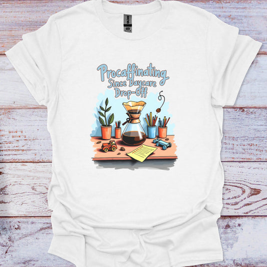 White t-shirt with a colorful graphic and text on a wooden surface