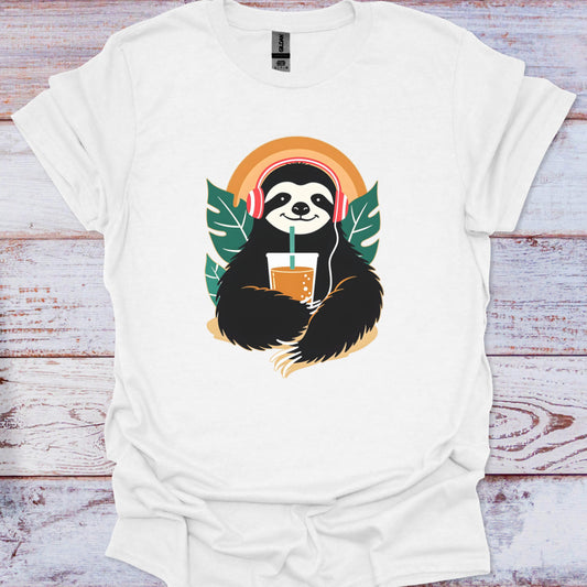 White t-shirt with a sloth graphic holding a drink and wearing headphones on a wooden surface.