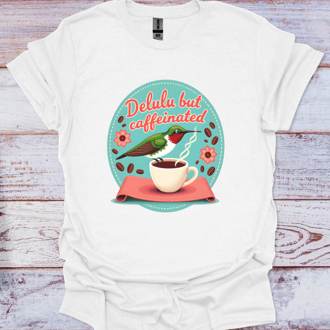 White t-shirt with a graphic design featuring a coffee cup, hummingbird, and text on a wooden surface.