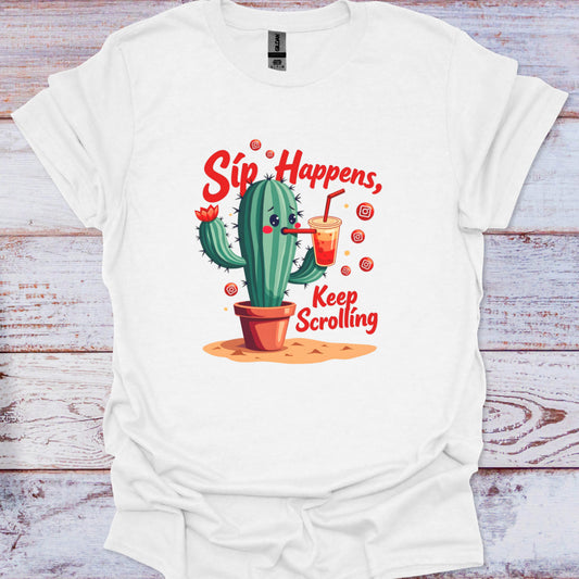 White t-shirt with a cactus graphic and text 'Sip Happens, Keep Scrolling' on a wooden surface.