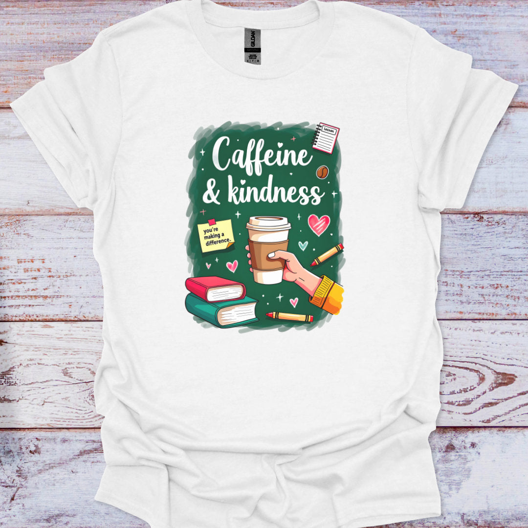 White t-shirt with 'Caffeine & Kindness' graphic design on a wooden surface