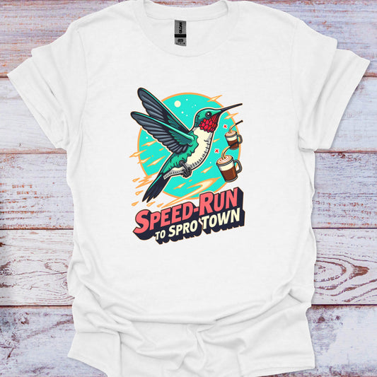 White t-shirt with a colorful hummingbird graphic and text on a wooden surface