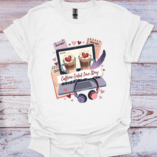 White t-shirt with a graphic design featuring coffee cups, a laptop, and text on a wooden surface.