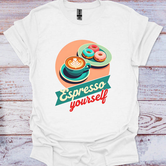 White t-shirt with a colorful graphic of a coffee cup and donuts, and the text 'Espresso yourself' on a wooden surface.