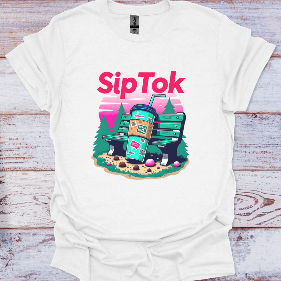 White t-shirt with 'SipTok' graphic design featuring a coffee cup and trees on a wooden surface.